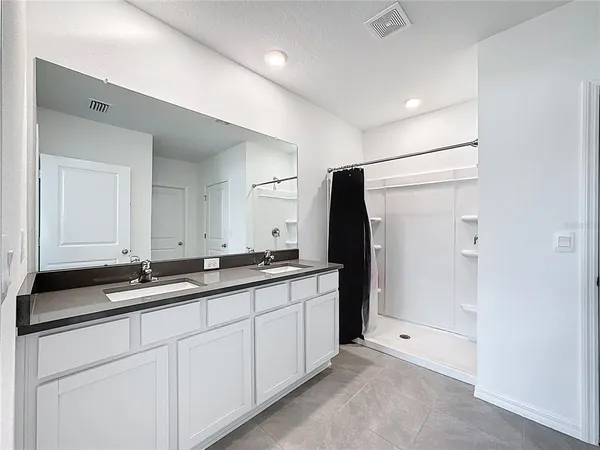 a bathroom with a sink a toilet and a shower
