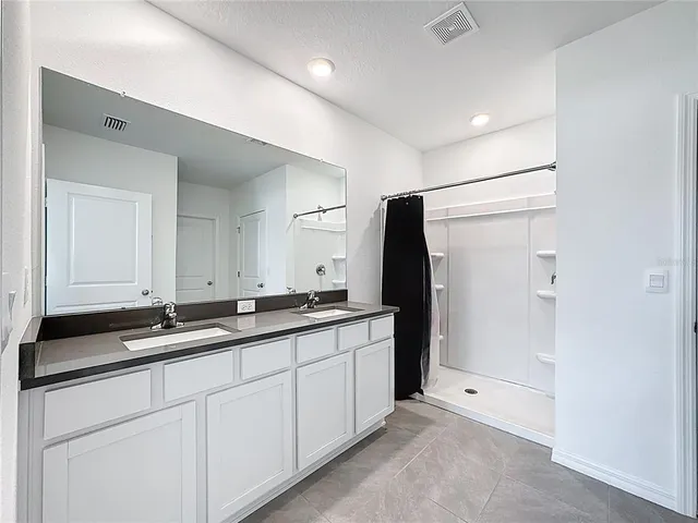 a bathroom with a sink a toilet and a shower