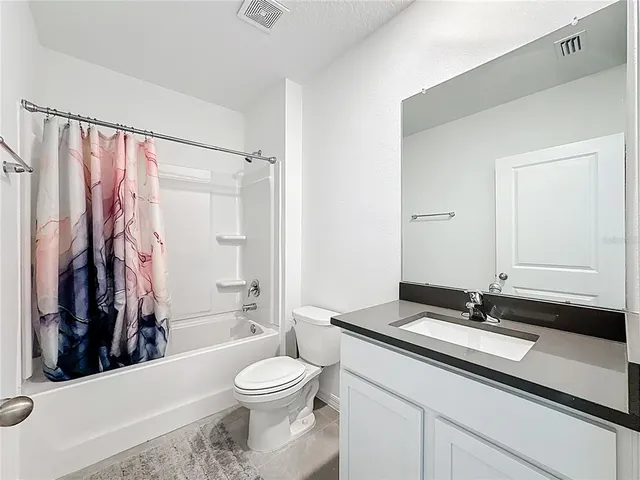 a view of a dining room with chairs and table