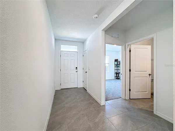 a kitchen with stainless steel appliances a stove a sink a refrigerator and white cabinets