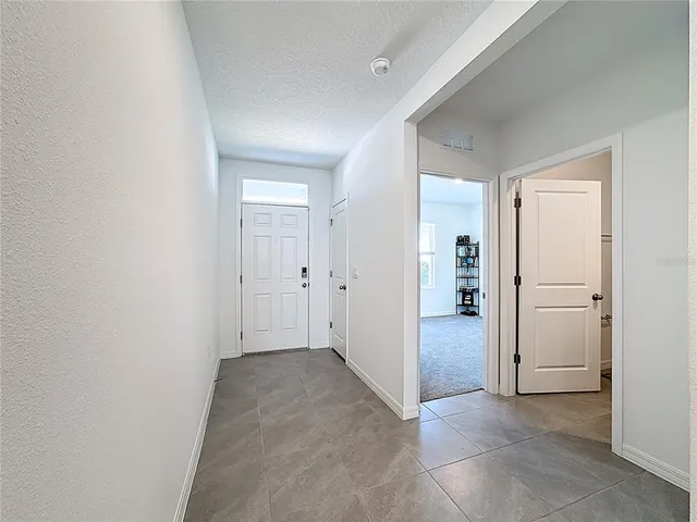 a kitchen with stainless steel appliances a stove a sink a refrigerator and white cabinets