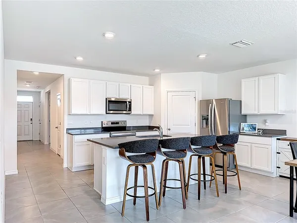 a view of a dining room with furniture and a large window