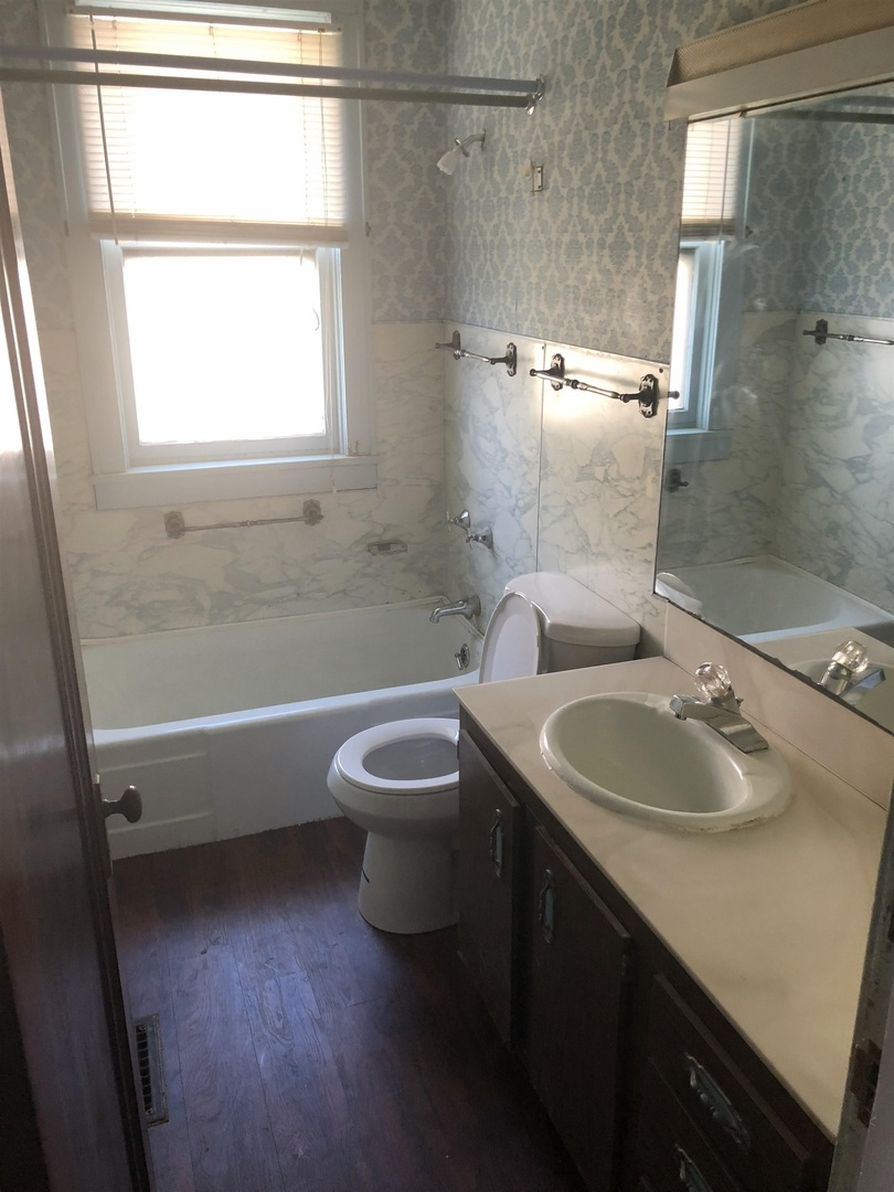 322 1st Avenue Clinton, IA 52732 - Photo 2 of 6 a bathroom with a sink toilet and shower