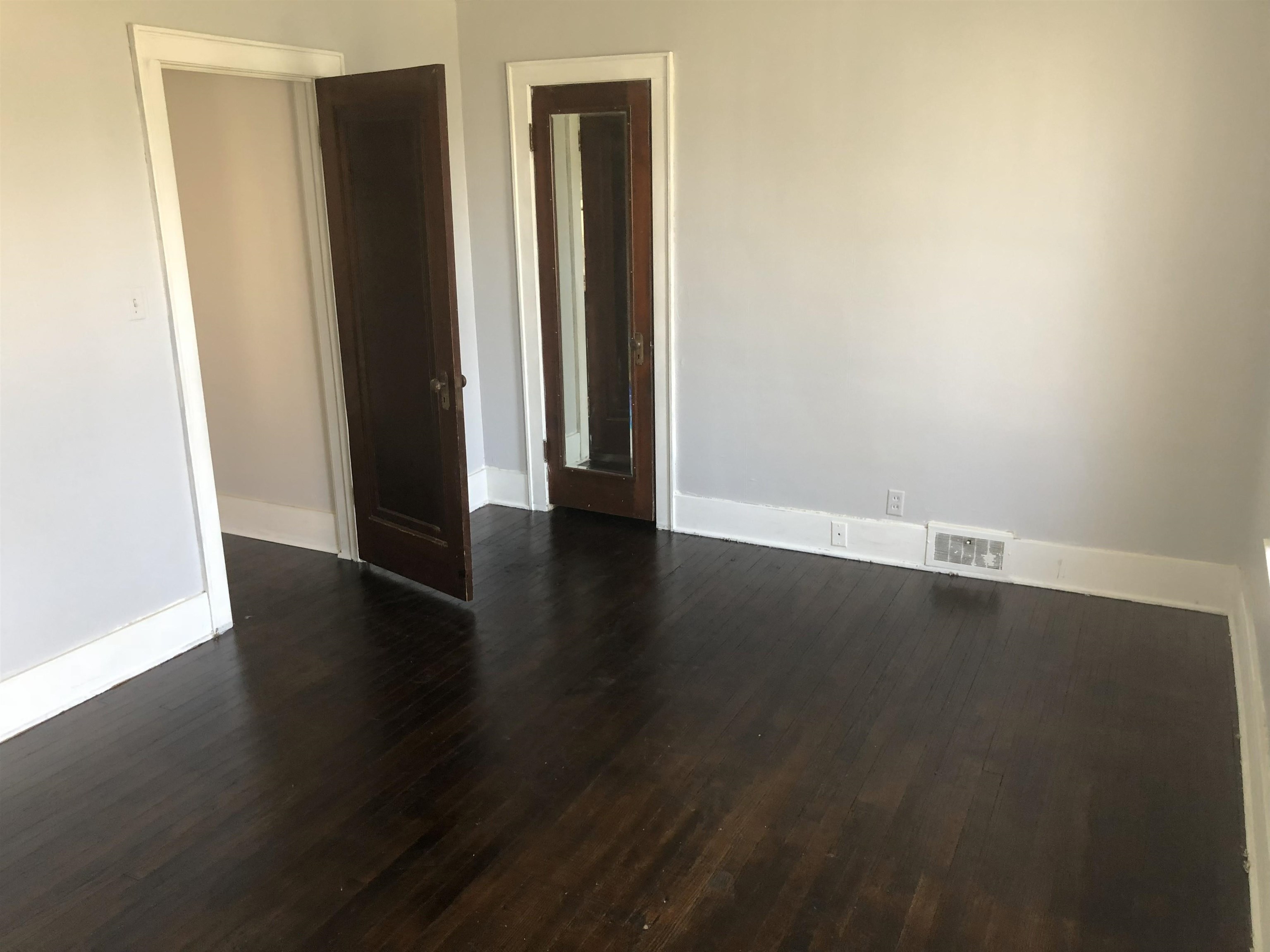 322 1st Avenue Clinton, IA 52732 - Photo 3 of 6 an empty room with wooden floor and closet