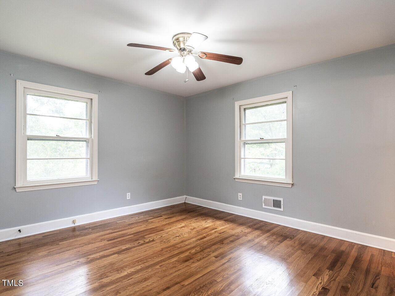 7800 White Oak Road Garner, NC 27529 - Photo 20 of 37 a view of an empty room with wooden floor and a window