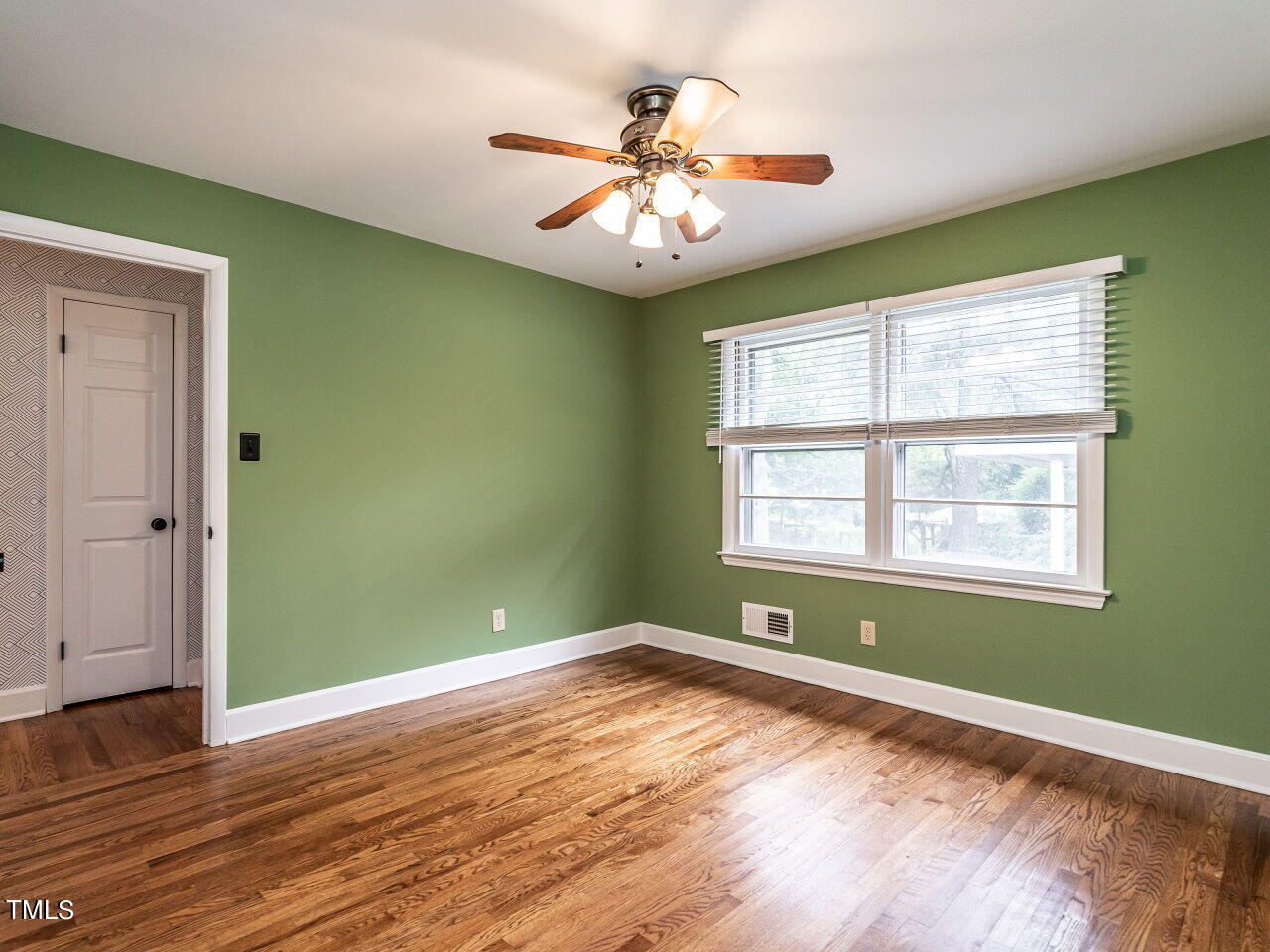 7800 White Oak Road Garner, NC 27529 - Photo 21 of 37 a view of an empty room with wooden floor and a window