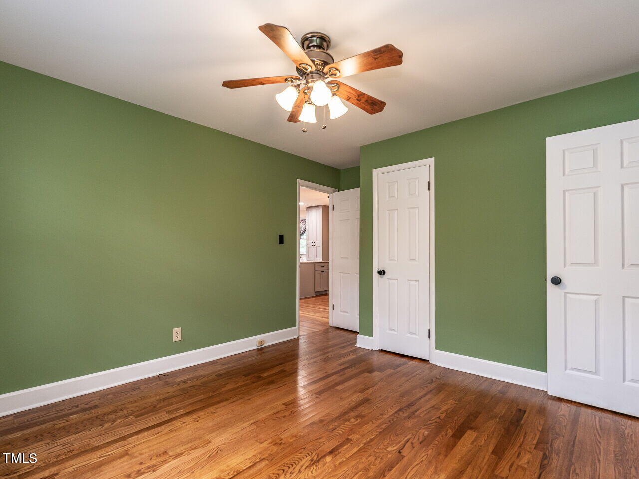 7800 White Oak Road Garner, NC 27529 - Photo 22 of 37 an empty room with wooden floor and fan