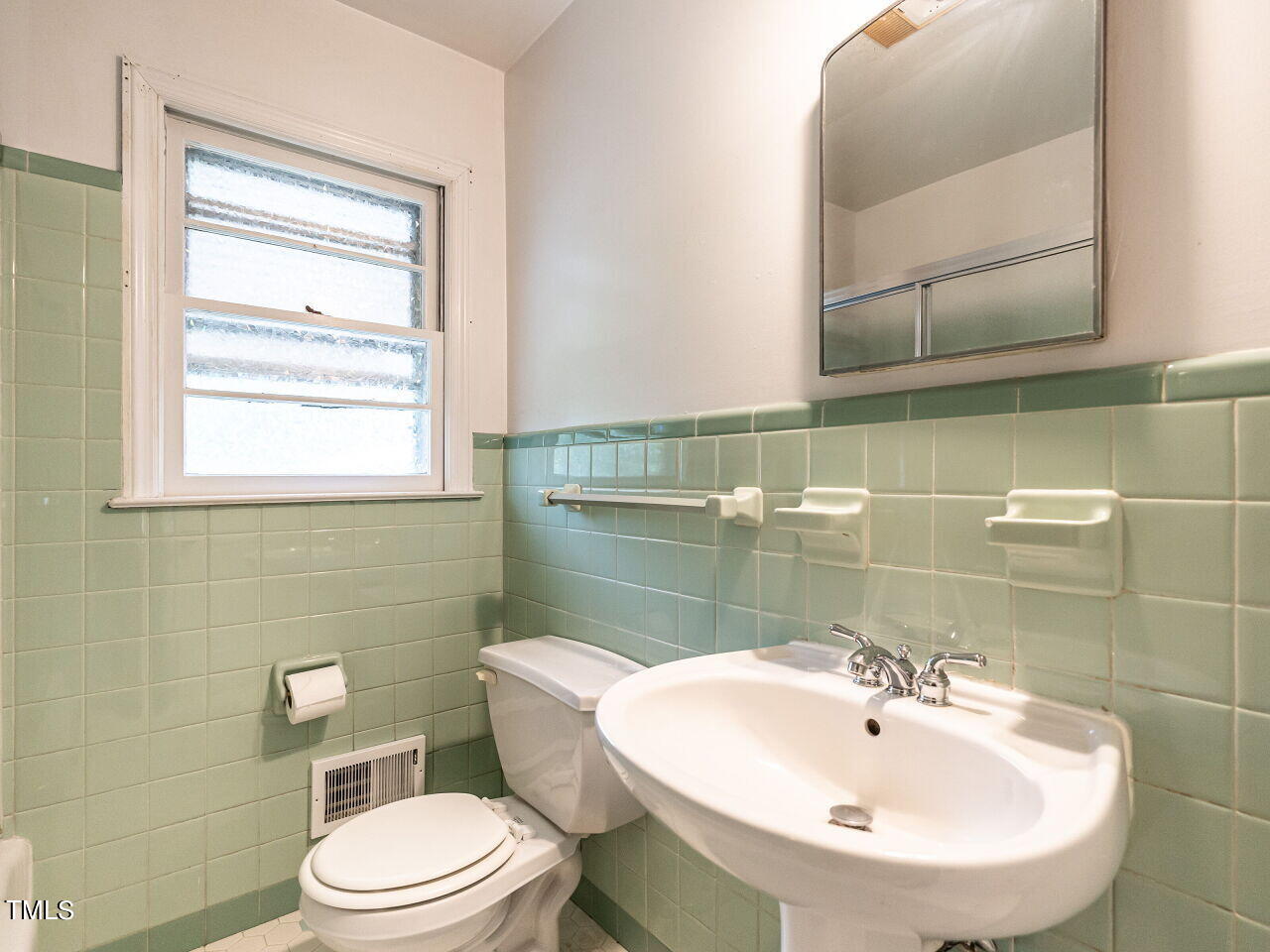 7800 White Oak Road Garner, NC 27529 - Photo 24 of 37 a bathroom with a sink a toilet and mirror