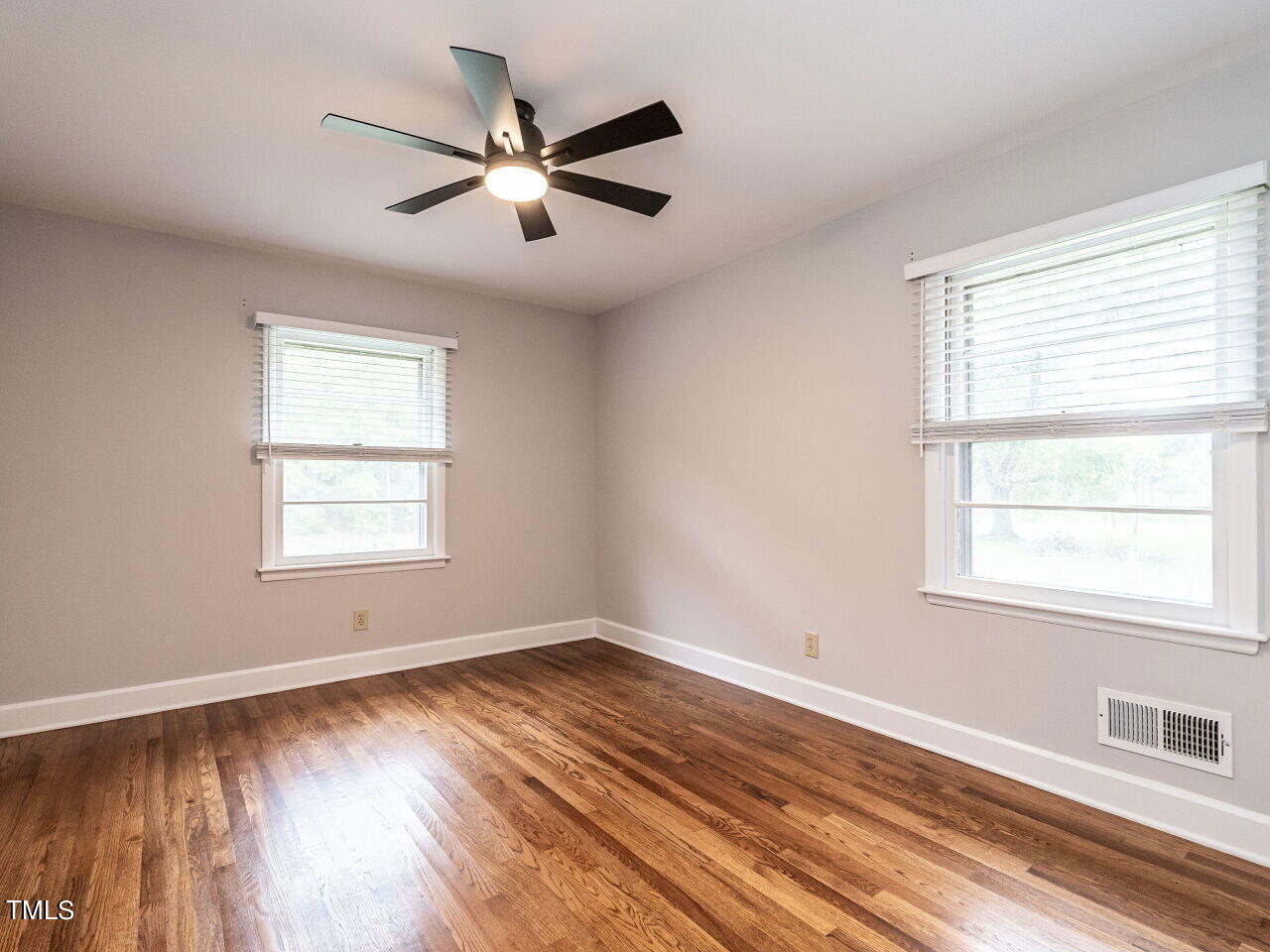 7800 White Oak Road Garner, NC 27529 - Photo 25 of 37 a view of an empty room with wooden floor and a window