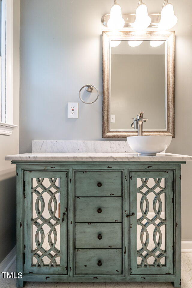 7800 White Oak Road Garner, NC 27529 - Photo 28 of 37 a bathroom with a sink a mirror and a vanity