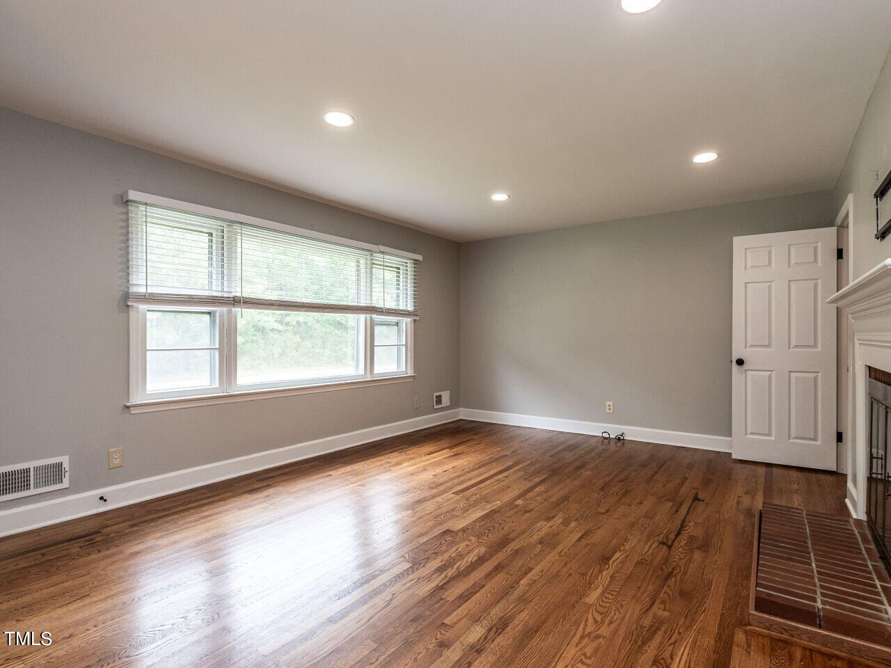 7800 White Oak Road Garner, NC 27529 - Photo 9 of 37 an empty room with wooden floor and windows