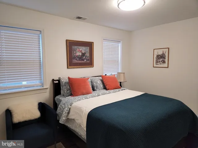 a bedroom with bed and a window