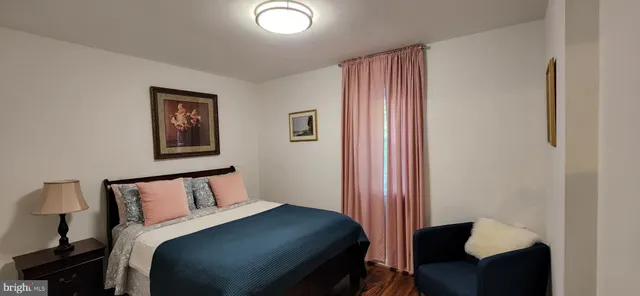 a bedroom with a bed and chair