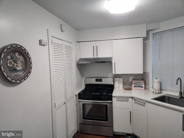 a kitchen with a stove and a sink