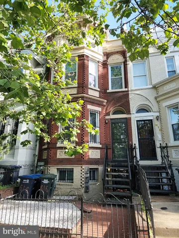 a front view of a house with many windows
