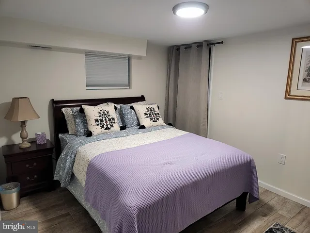 a bedroom with a bed and a night stand