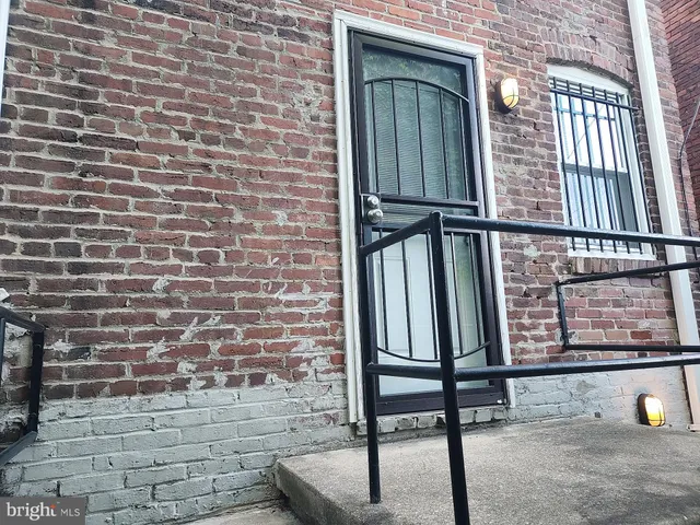 a view of a brick wall with a chair