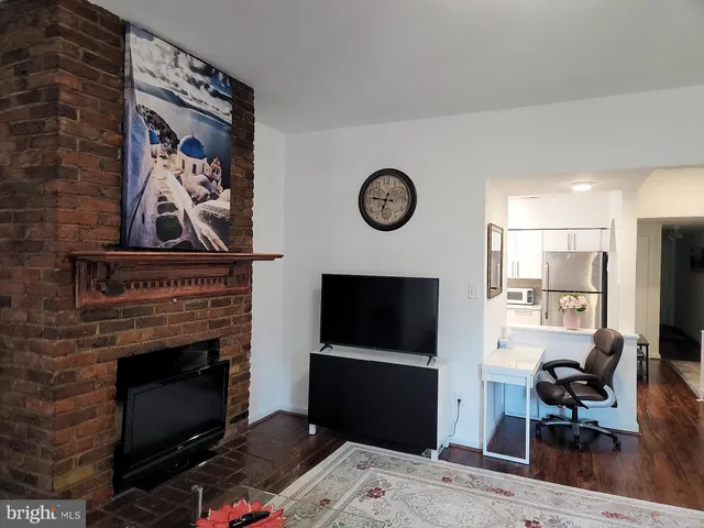 a living room with a fireplace and a flat screen tv