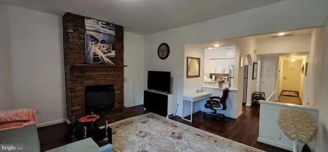 a living room with furniture mirror and a flat screen tv
