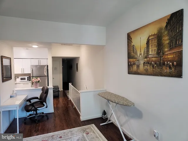 a living room with stainless steel appliances kitchen island granite countertop furniture and a view of kitchen