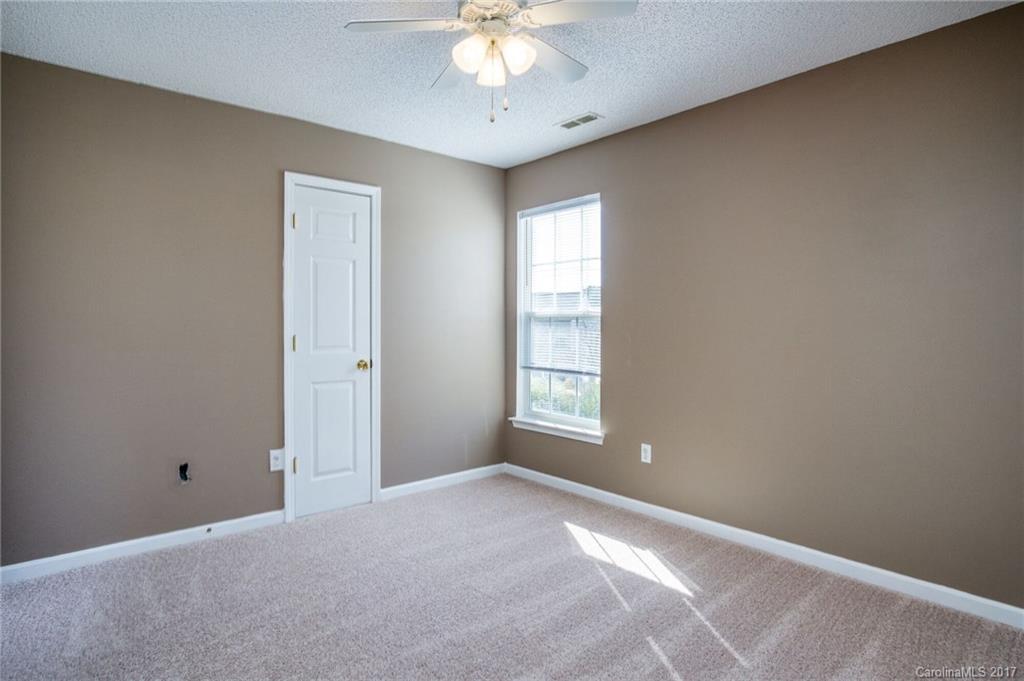 7474 Fallen Timber Lane Tega Cay, SC 29708 - Photo 22 of 24 a view of an empty room with a window