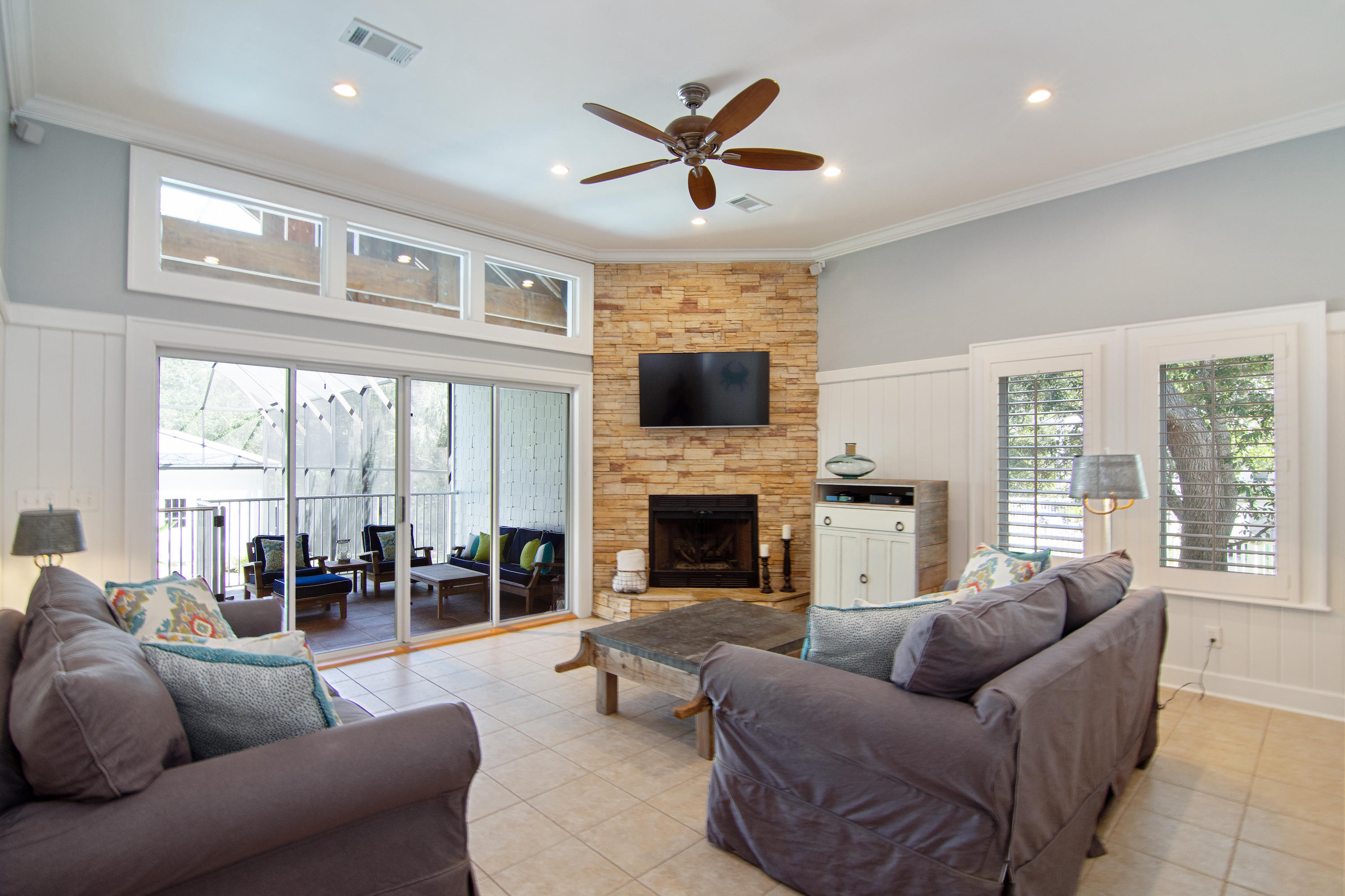 376 Seabreeze Circle Inlet Beach, FL 32461 - Photo 12 of 58 a living room with furniture a fireplace and a large window with garden view