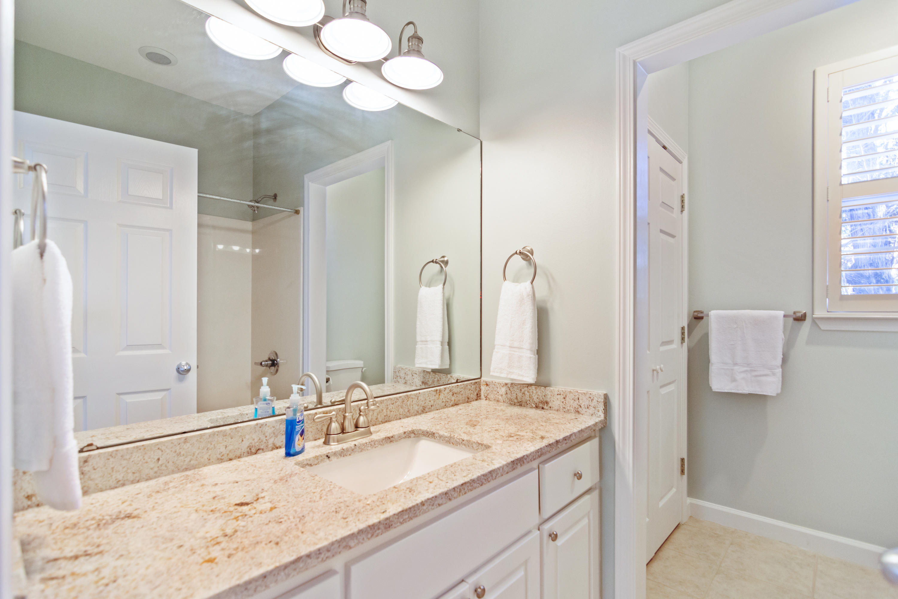 376 Seabreeze Circle Inlet Beach, FL 32461 - Photo 32 of 58 a bathroom with a granite countertop sink and a mirror