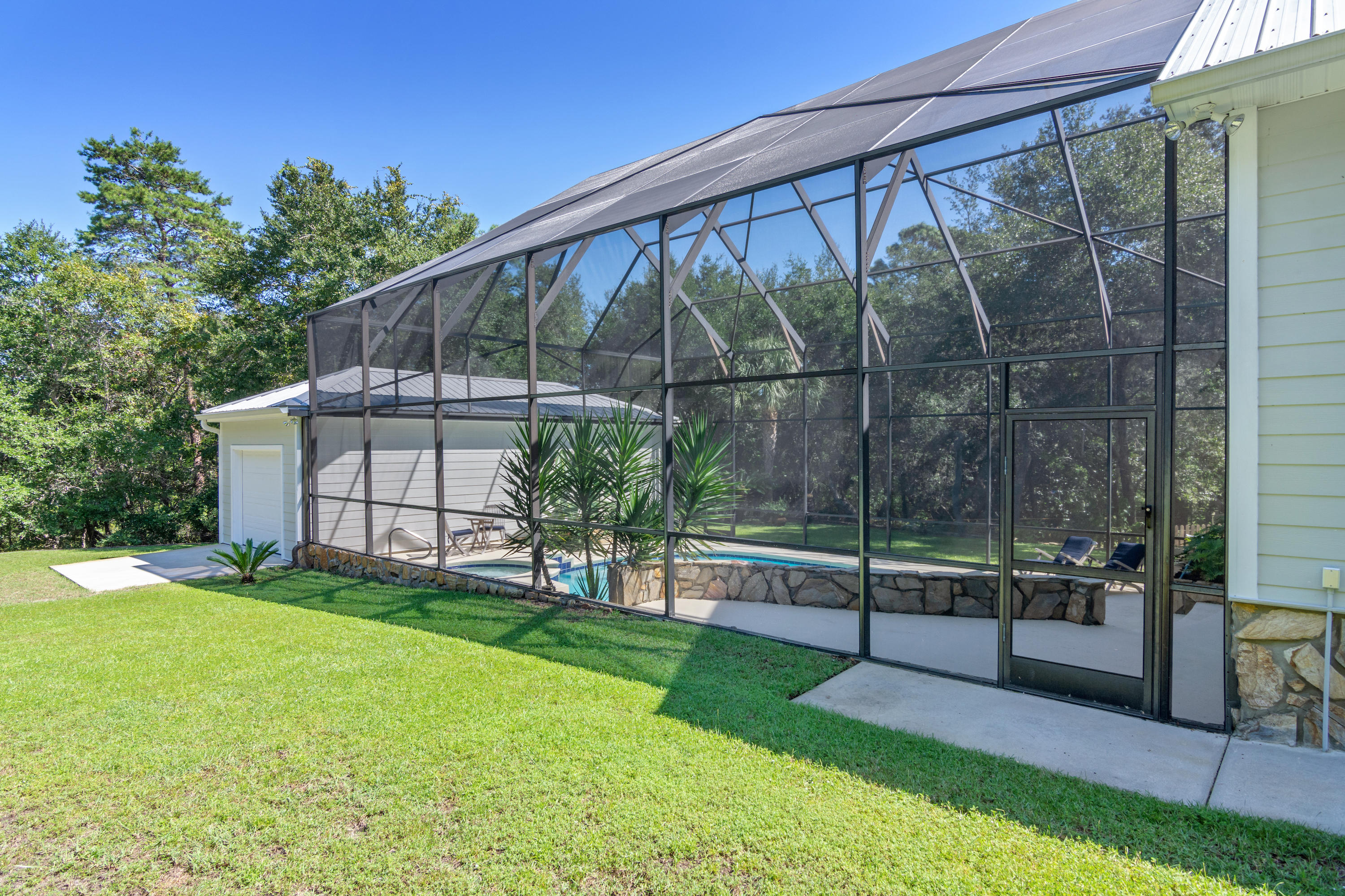376 Seabreeze Circle Inlet Beach, FL 32461 - Photo 49 of 58 a view of a backyard with a garden and deck