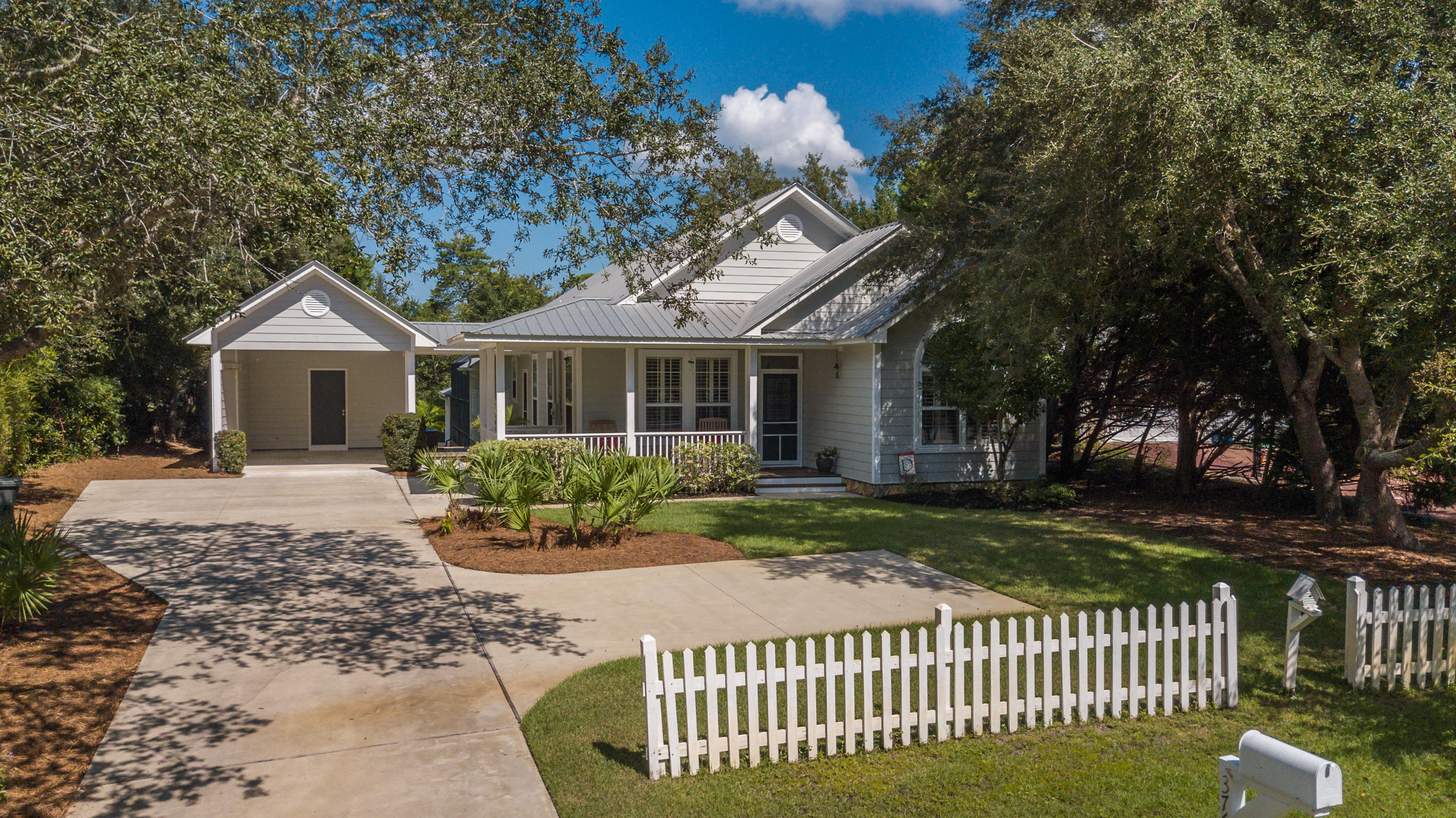 376 Seabreeze Circle Inlet Beach, FL 32461 - Photo 9 of 58 a front view of a house with a garden