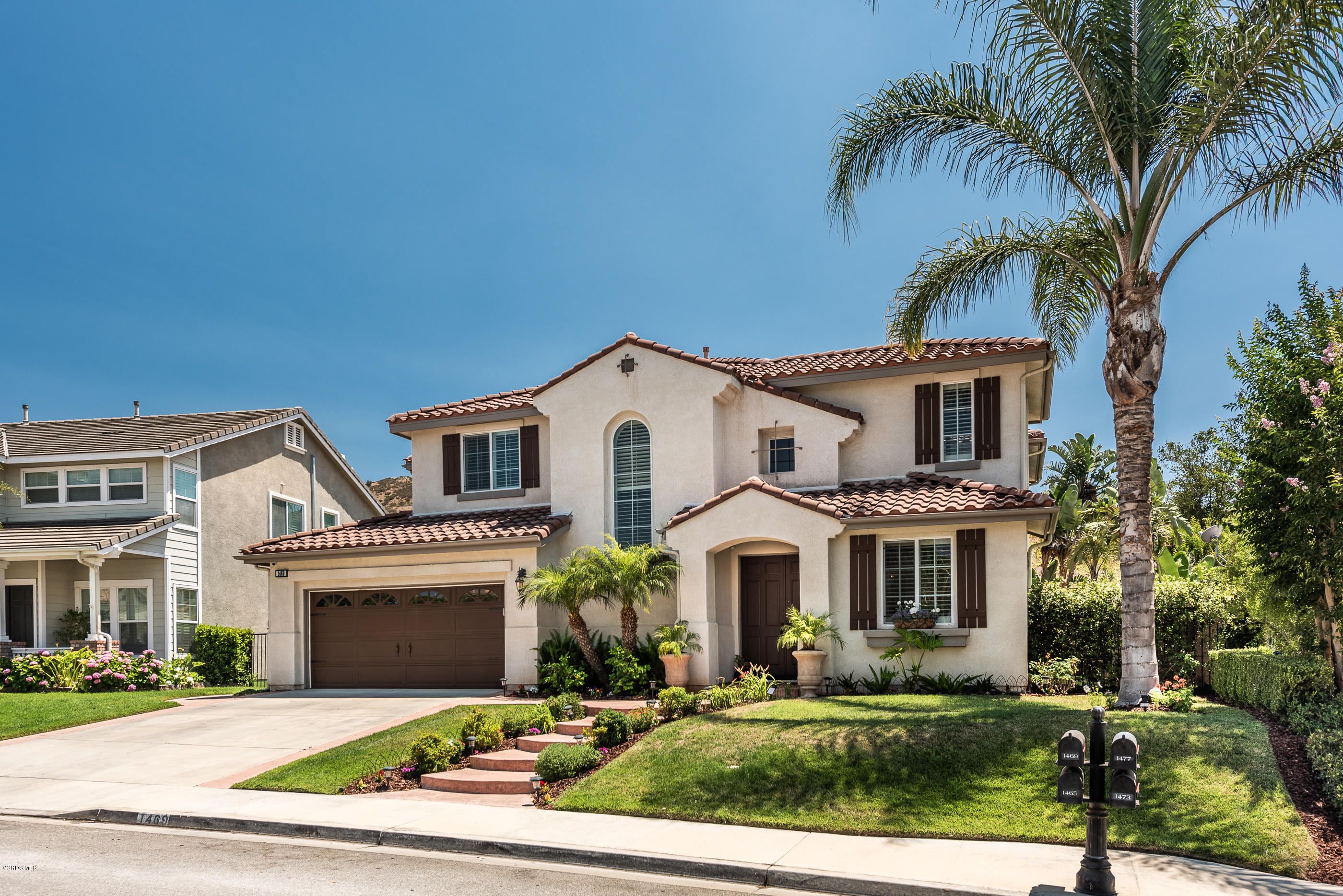 1469 Hidden Ranch Drive Simi Valley, CA 93063 - Photo 2 of 49 a view of white house with a yard and palm trees