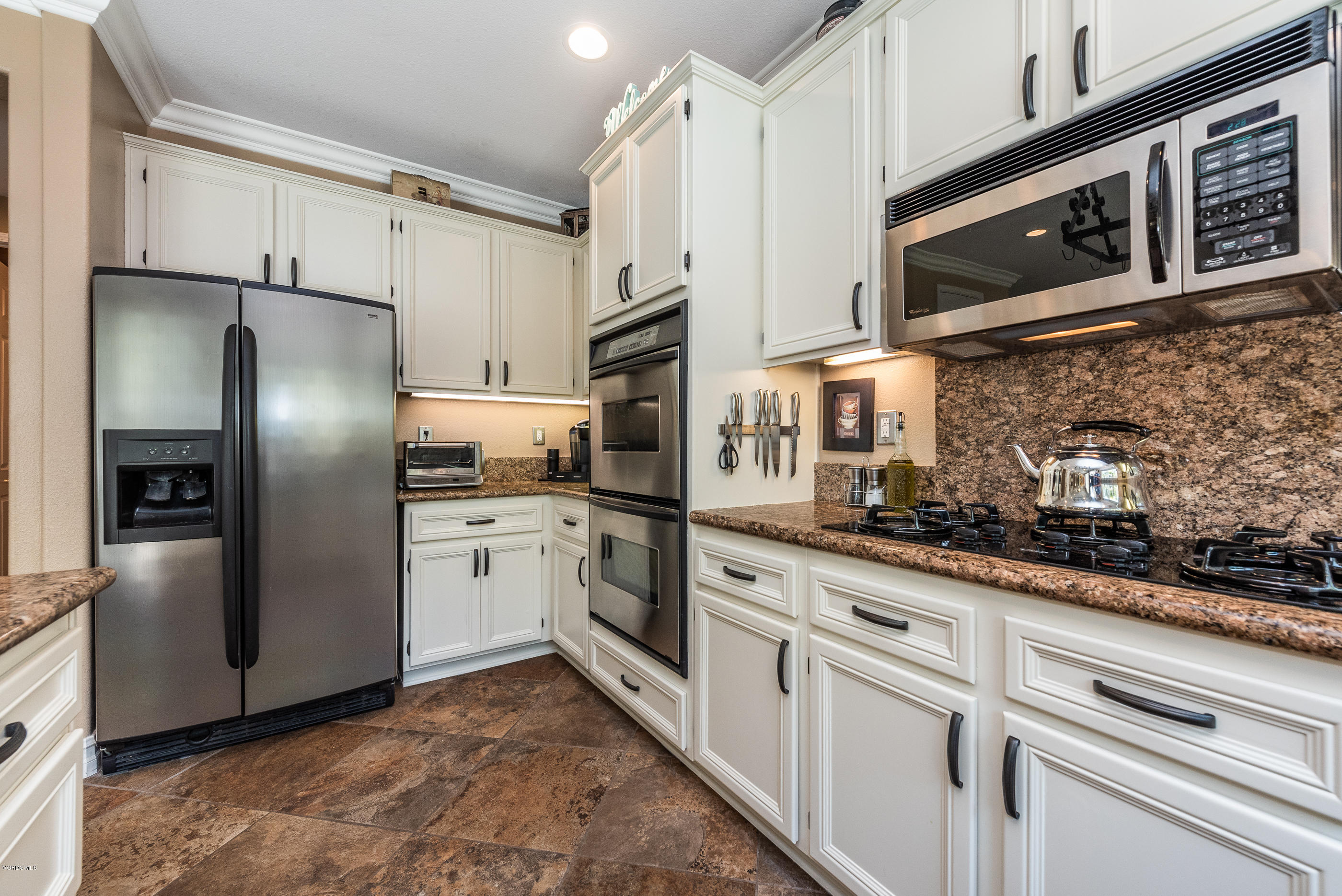 1469 Hidden Ranch Drive Simi Valley, CA 93063 - Photo 20 of 49 a kitchen with stainless steel appliances granite countertop a refrigerator a stove and a sink with granite countertops