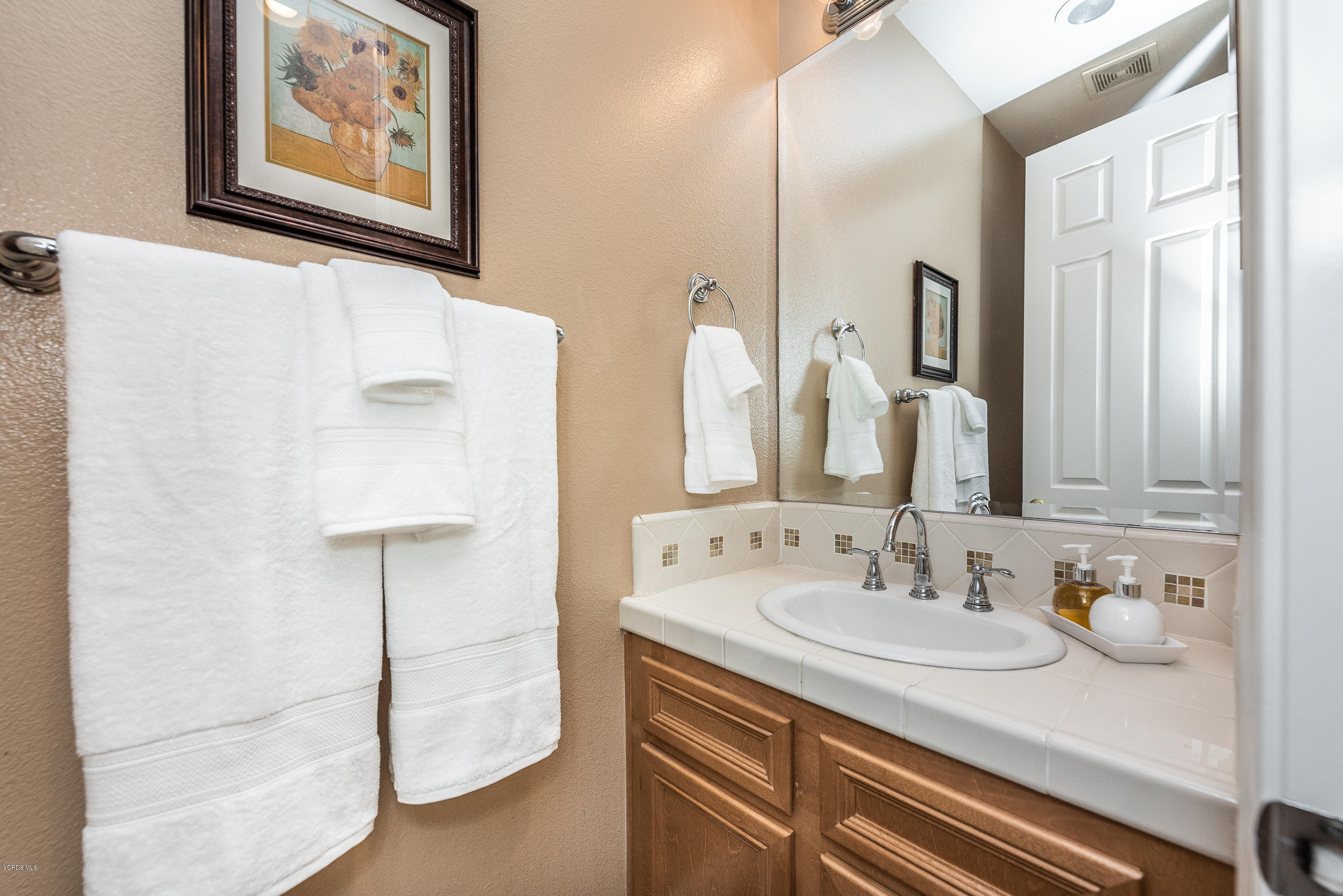 1469 Hidden Ranch Drive Simi Valley, CA 93063 - Photo 25 of 49 a bathroom with a sink and a mirror