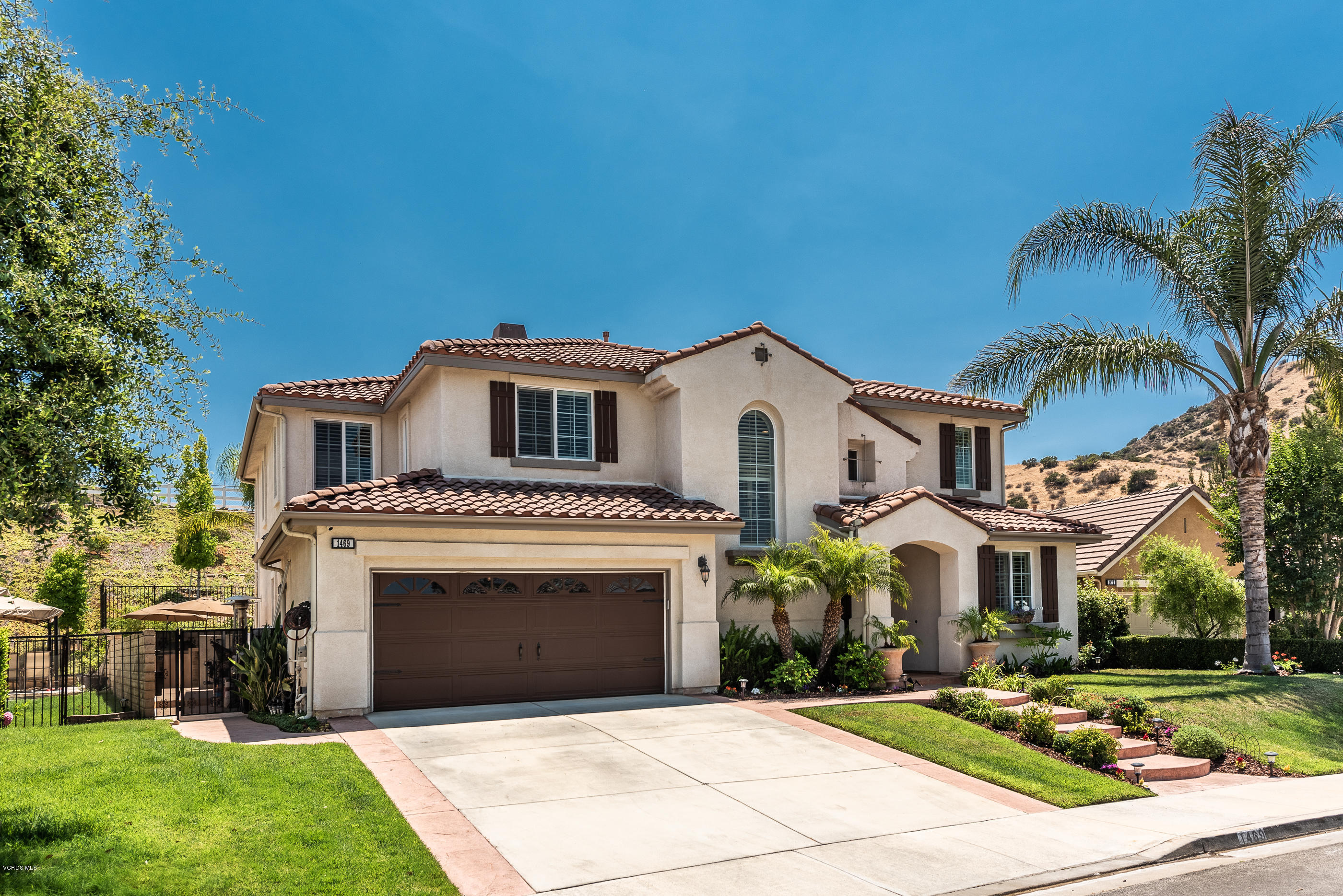 1469 Hidden Ranch Drive Simi Valley, CA 93063 - Photo 4 of 49 a view of a white house with a yard