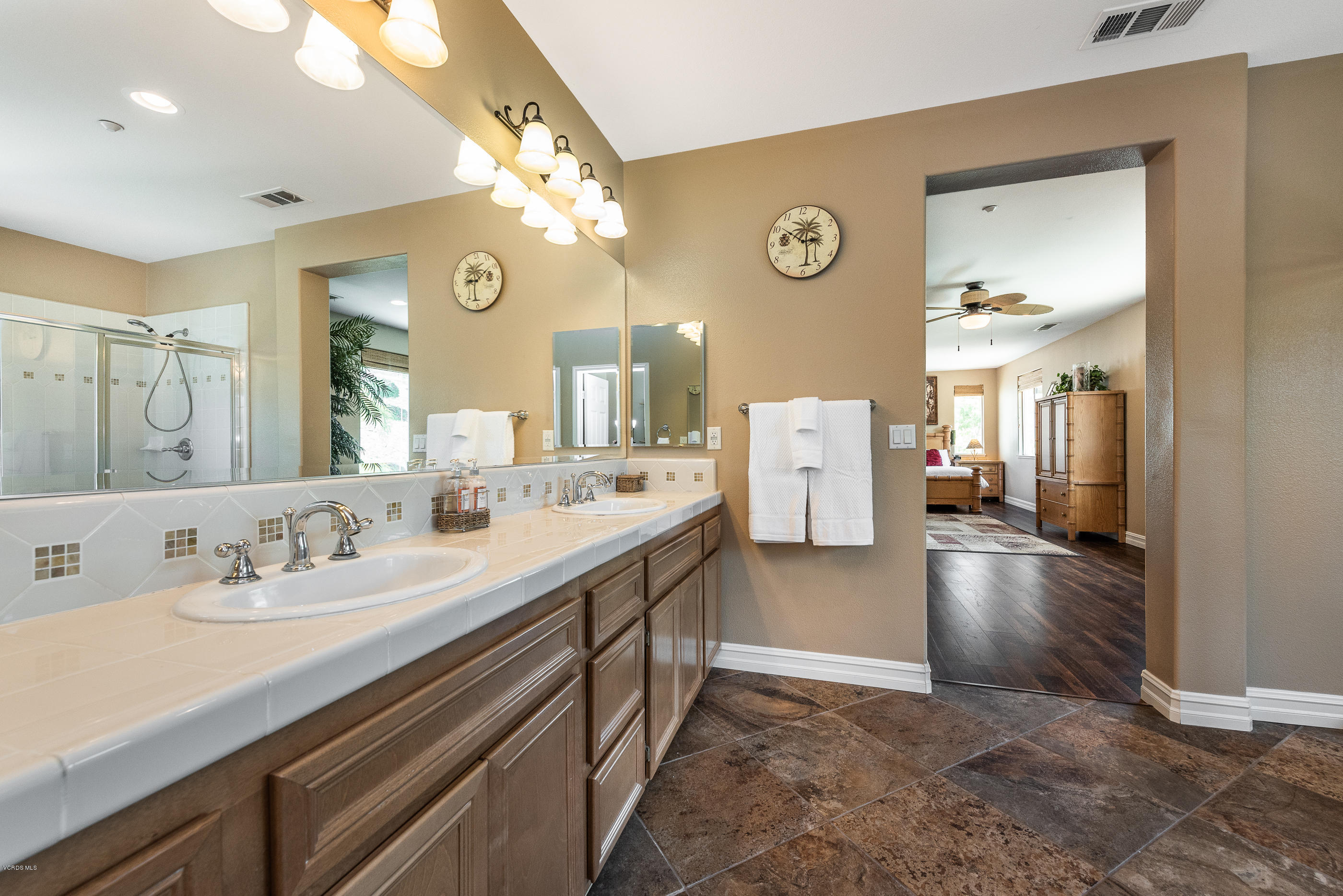 1469 Hidden Ranch Drive Simi Valley, CA 93063 - Photo 33 of 49 a bathroom with a sink a large mirror and a shower