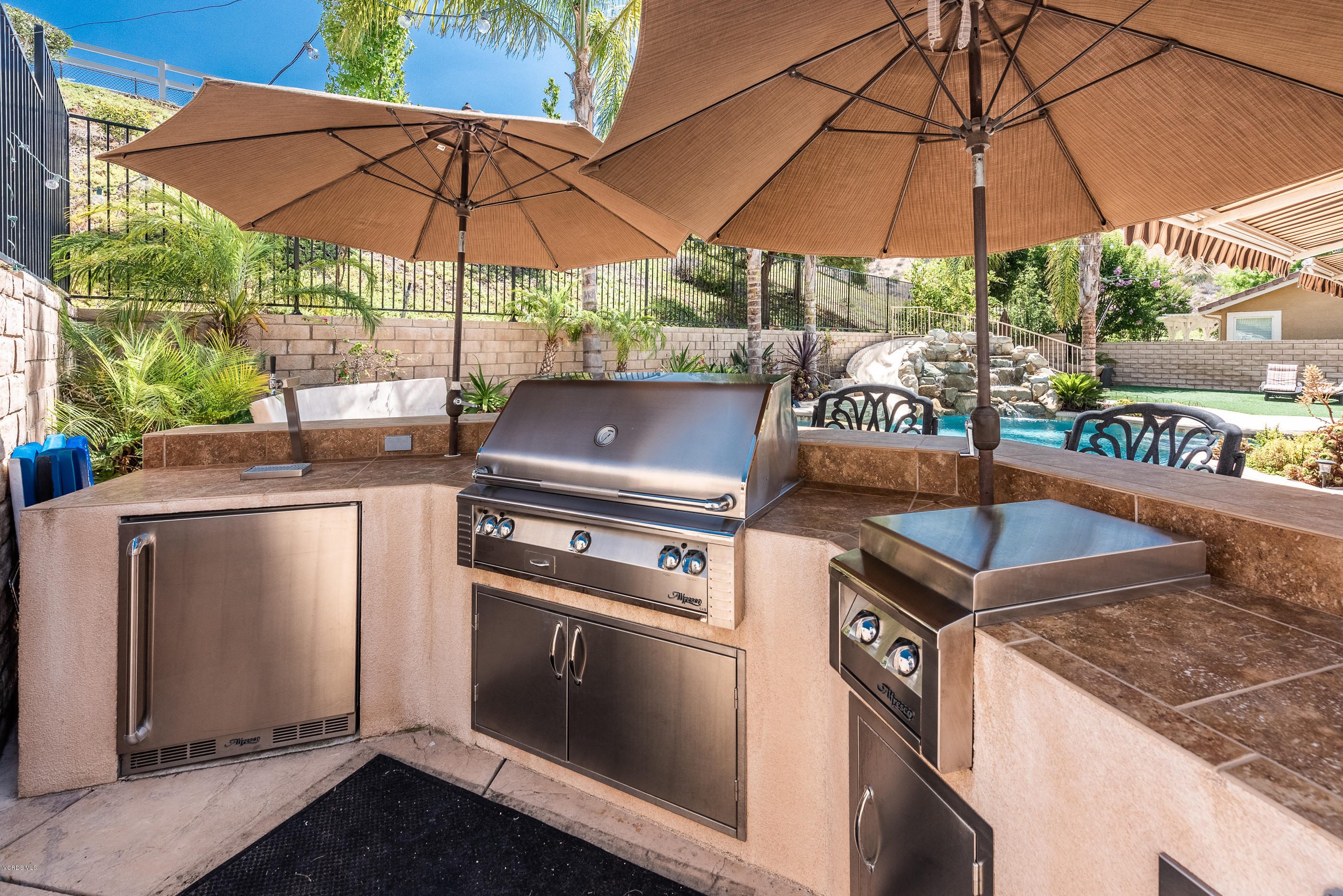 1469 Hidden Ranch Drive Simi Valley, CA 93063 - Photo 45 of 49 a table and chairs under an umbrella