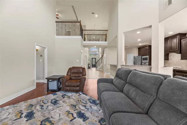 a living room with furniture and a wooden floor