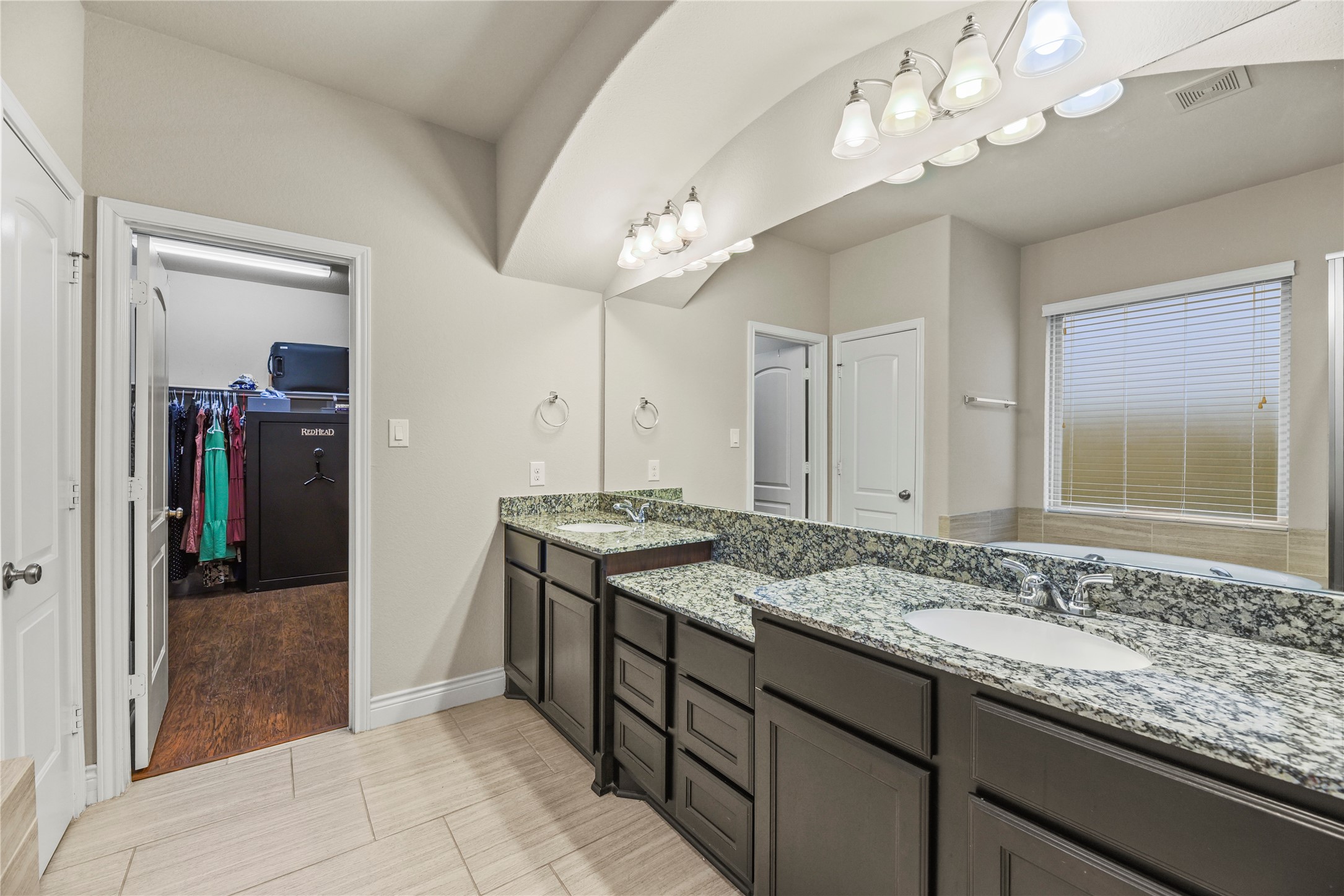 3834 Trophy Ridge Drive Spring, TX 77386 - Photo 22 of 43 a bathroom with a granite countertop sink a large mirror and a shower