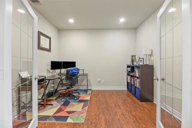 a view of a workspace with furniture and a book shelf