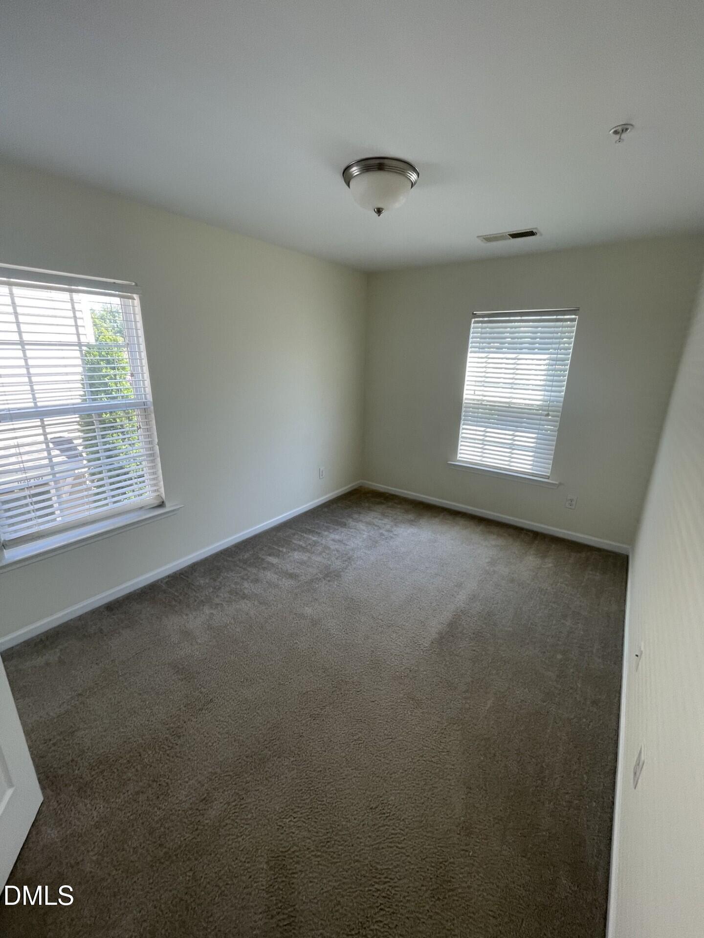 1130 Renewal Place, Unit 100 Raleigh, NC 27603 - Photo 12 of 17 an empty room with windows