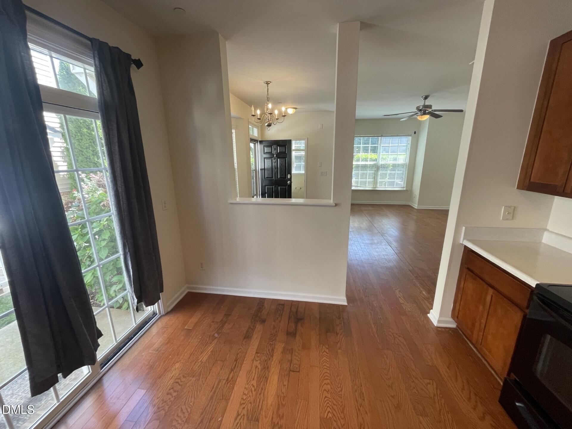 1130 Renewal Place, Unit 100 Raleigh, NC 27603 - Photo 4 of 17 wooden floor in an empty room with a window