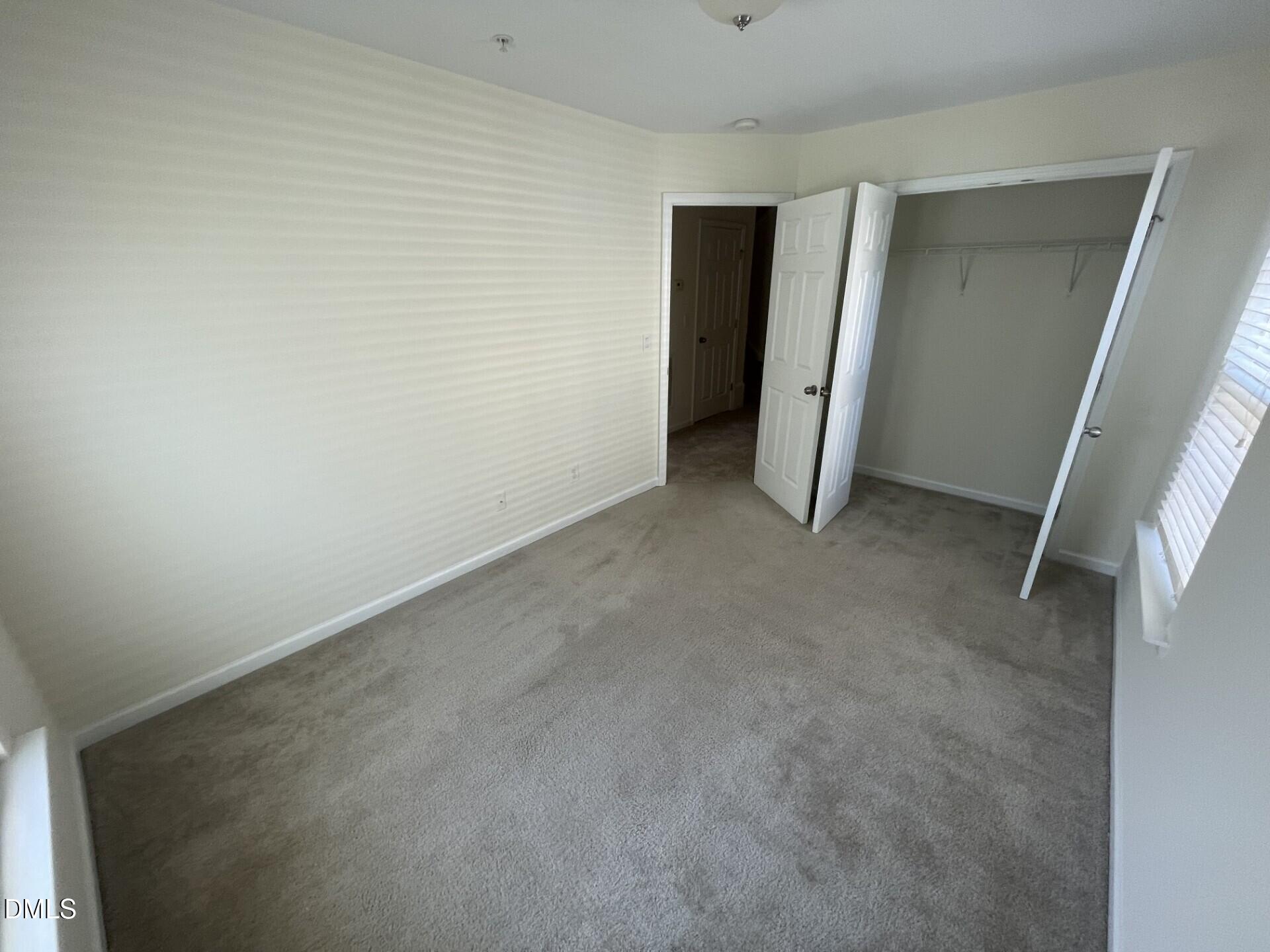 1130 Renewal Place, Unit 100 Raleigh, NC 27603 - Photo 8 of 17 an empty room with closet