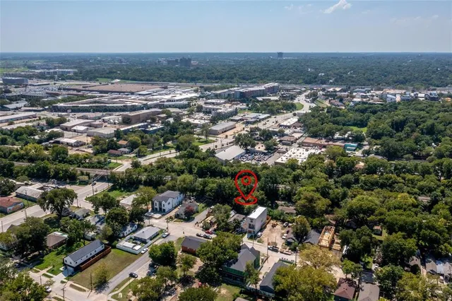 an aerial view of a house with a yard and lake view