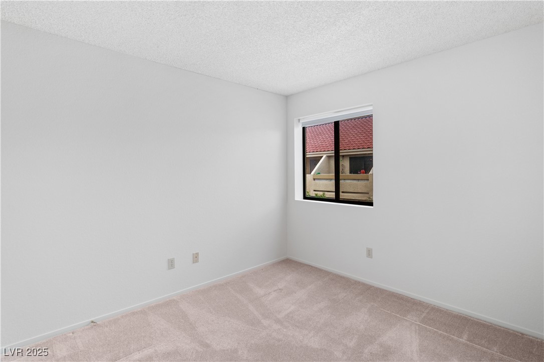 3740 Desert Marina Drive, Unit 2 Laughlin, NV 89029 - Photo 21 of 75 Carpeted Second Bedroom featuring a textured ceiling and baseboards