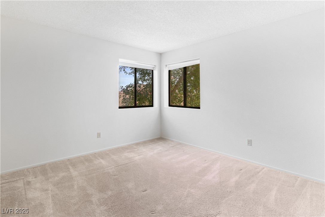 3740 Desert Marina Drive, Unit 2 Laughlin, NV 89029 - Photo 28 of 75 Carpeted Primary bedroom with a textured ceiling and baseboards
