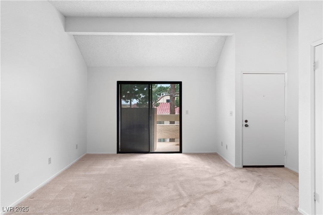 3740 Desert Marina Drive, Unit 2 Laughlin, NV 89029 - Photo 7 of 75 Living room featuring light carpet and a textured ceiling