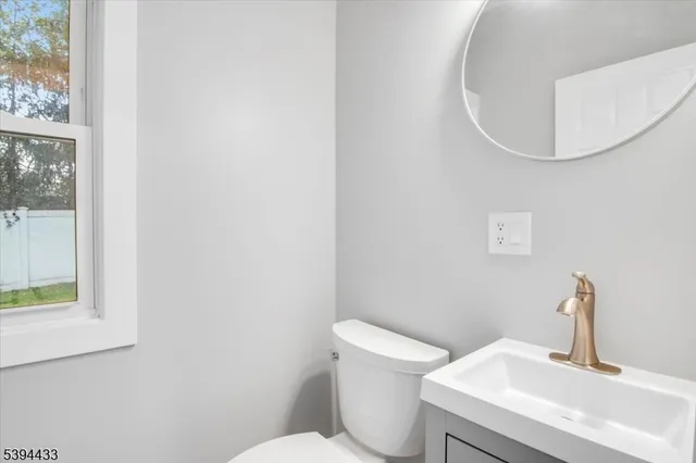 a white toilet sitting next to a bathroom sink