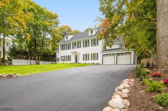 a view of house with outdoor space and trees around
