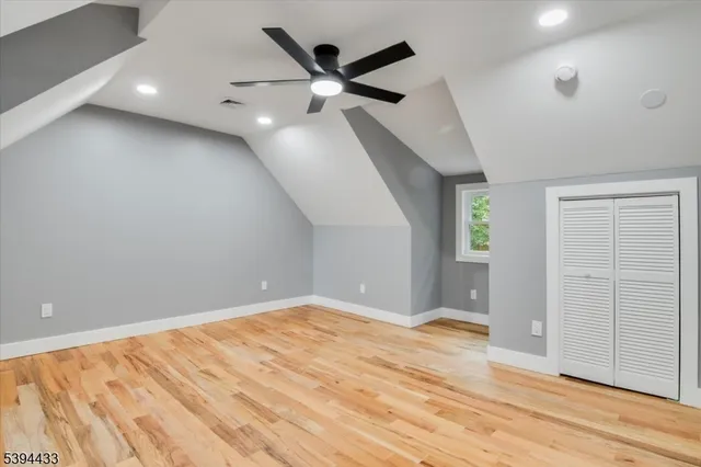 an empty room with window and ceiling fan