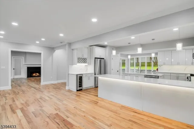 a view of kitchen with furniture and refrigerator