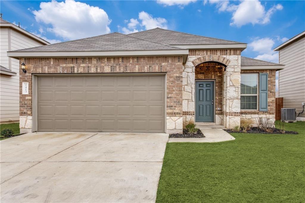 1413 Cliffbrake Way Georgetown, TX 78626 - Photo 1 of 30 a front view of a house with a garden